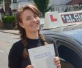 Maria with Driving test pass certificate